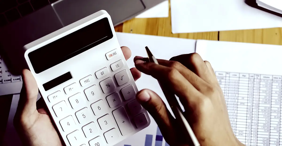 Person using calculator in left hand