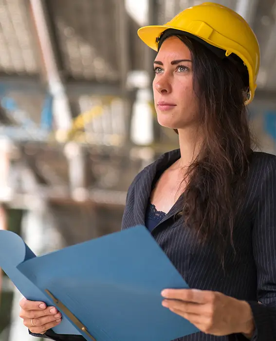 Woman in hard hat holding a folder